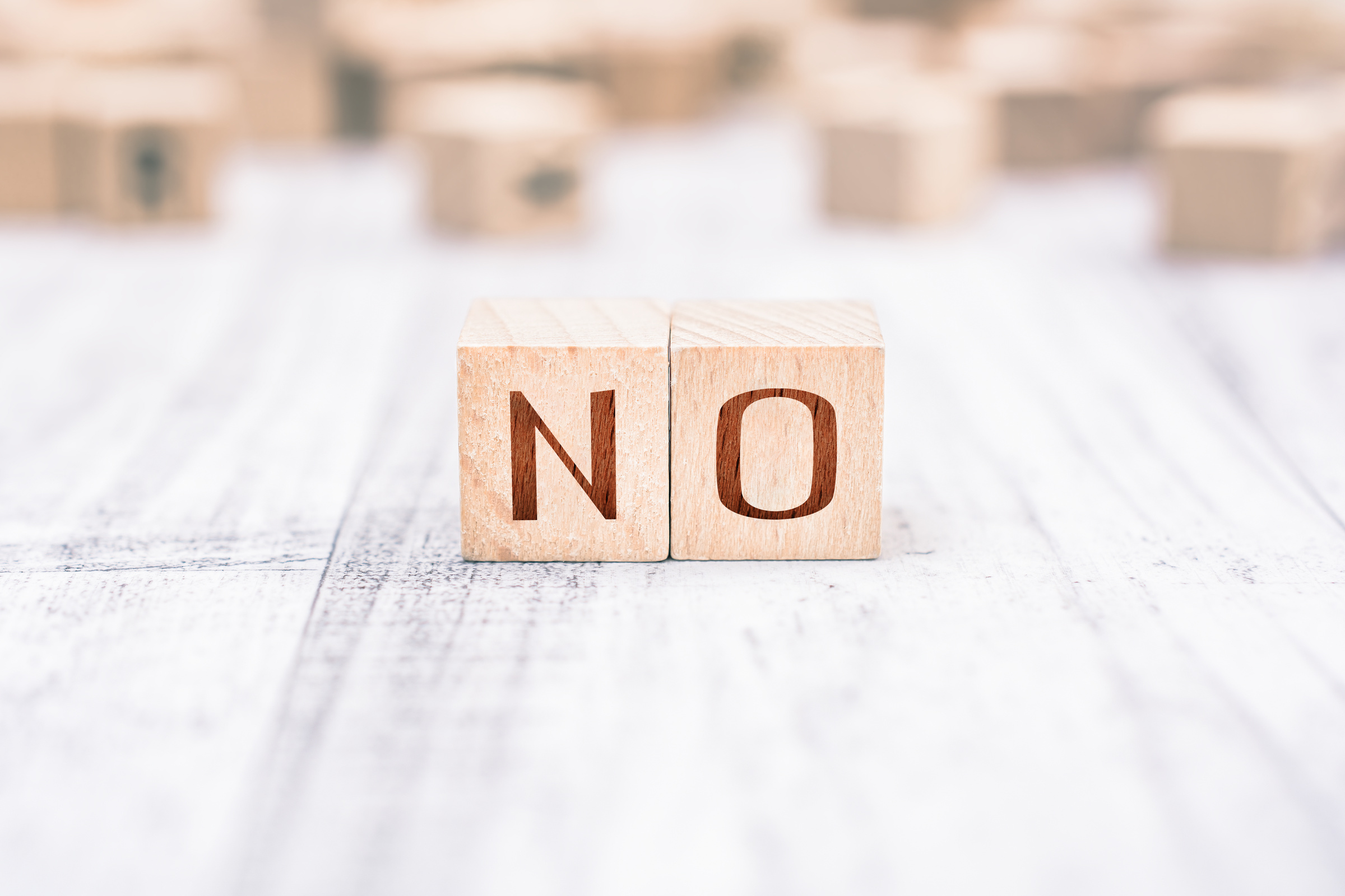 The Word No Formed by Wooden Blocks on a White Table